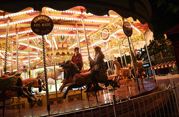 Members of the public ride a carousel adjacent to the 'St Nicholas Fair' Christmas market in the city centre of York, Northern England on December 3, 2014. AFP PHOTO / OLI SCARFF        (Photo credit should read OLI SCARFF/AFP/Getty Images)