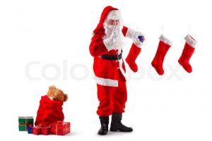 santa-claus-stands-and-puts-christmas-gifts-in-socks