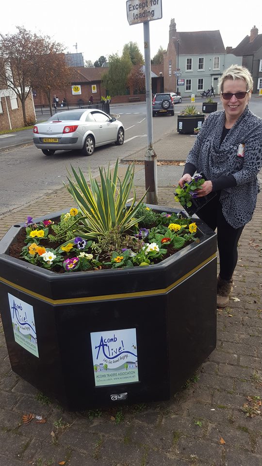 Cllr Sue Hunter with one f the newly planted containers in Front St